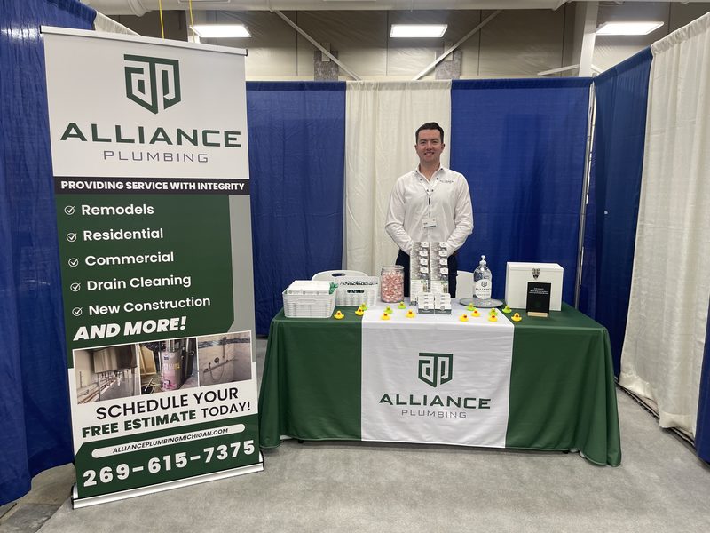 Alliance Plumbing technician with branded shirt — got a plumbing question? We can help
